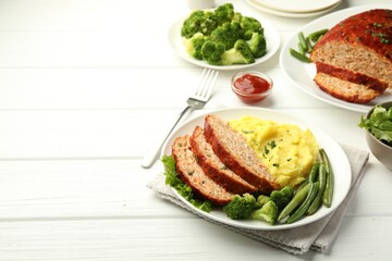 Delicious baked turkey meatloaf with mashed potato served on white wooden table, space for text