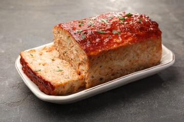 Delicious baked turkey meatloaf on grey table, closeup