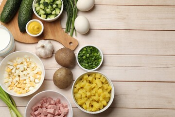Ingredients for okroshka soup on light wooden table, flat lay. Space for text