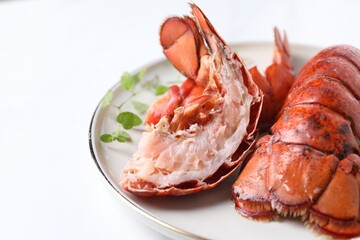 Delicious tails of boiled lobsters served on white table, closeup. Space for text