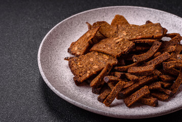 Crispy homemade brown bread crackers or croutons with seeds and grains