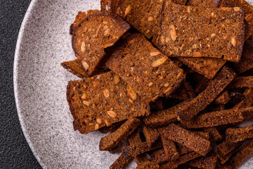 Crispy homemade brown bread crackers or croutons with seeds and grains