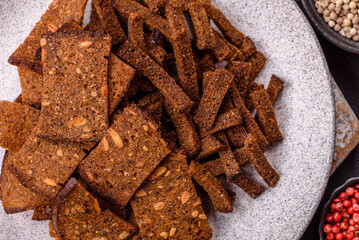 Crispy homemade brown bread crackers or croutons with seeds and grains
