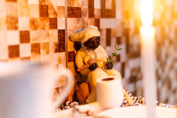 Offering for old black man, Umbanda Afro-Brazilian religion, Axé, Orixá, Saravá! The Umbanda ritual. Umbanda sculpture object. Candle, light, religion, African. Rio de Janeiro, Brazil. © Cristian