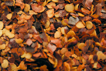 Colorful dried spices scattered on a surface, showcasing a variety of textures and hues