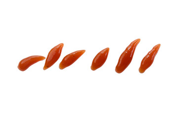 Orange condiment droplets on plain surface