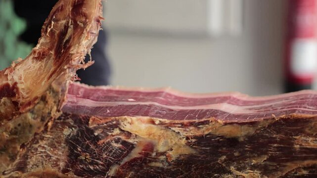 A close-up image of hands skillfully carving meat, showcasing precision and expertise in butcher techniques, capturing the art of meat preparation beautifully.