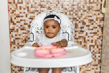 Spontaneous reaction of a child when introduced to food, eating for the first time. Rio de Janeiro,...