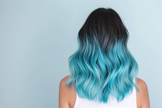Black to turquoise ombre hairstyle, soft wavy curls on medium length hair, back view of modern female look, gradient hair dye style for beauty and fashion portrait on pastel background

