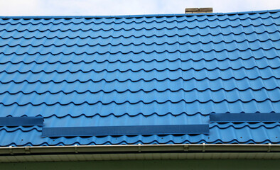 The roof of the house is covered with metal tiles