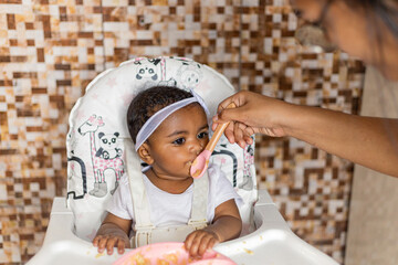 Spontaneous reaction of a child when introduced to food, eating for the first time. Rio de Janeiro,...