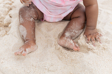 Happy baby girl on her first time at the beach playing. Rio de Janeiro, Brazil.