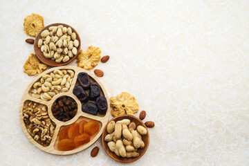 Concept of the Jewish holiday Tu Bishvat. Heart-shaped arrangement of dried fruits and nuts