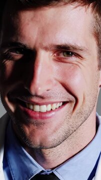 Medical professional in white coat displaying friendly demeanor, shifting facial expressions and head angles while facing camera lens