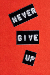 Never give up. Inspirational motivational quote on red background.