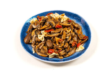 A blue plate of fried mushrooms with bow tie pasta isolated on white