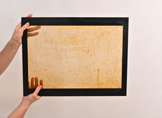 inner glass of the oven is dirty with grease stains. In the hands on a white background