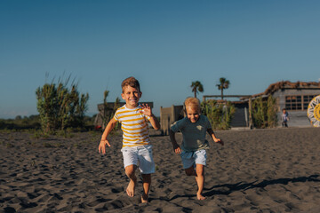 Two children running on the beach