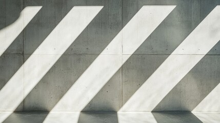 Obraz premium Abstract shadows create diagonal patterns on a concrete wall, emphasizing light and space.