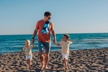 Father and two boys on a beach
