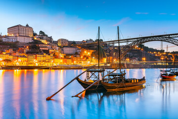 Panoramic view of Oporto old town at sunrise in Portugal - Porto cityscape at Douro riverbank
