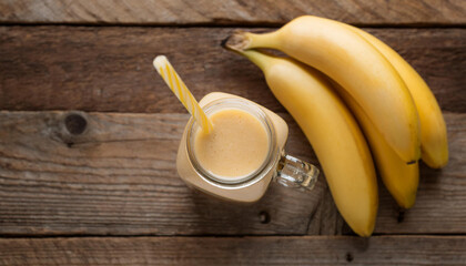 Tasty banana smoothie in glass mason jar. Healthy and sweet cocktail. Delicious natural drink.
