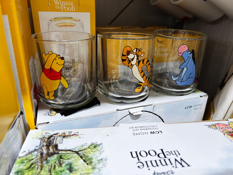 Kyiv, Ukraine - February 05, 2025: Glass tumblers with Winnie The Pooh cartoon characters displayed on store shelves for sale