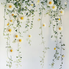 Beautiful floral arrangement with daisies and greenery hanging down against light background, creating serene and fresh atmosphere