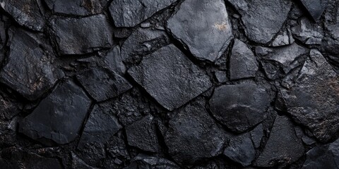 Fototapeta premium Close-up image of black coal. The coal is dark, textured and appears to be freshly extracted from the earth.