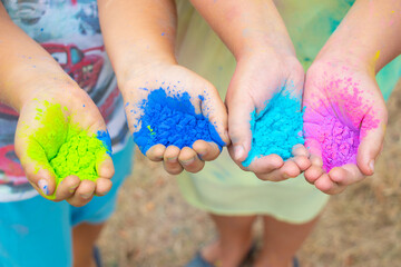 Childrenˇ's hands full of colorful holi powder used usually on celebrations in India or Run event in the Czech Republic.