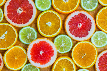Citrus fruit background with sliced f oranges lemons lime tangerines and grapefruit