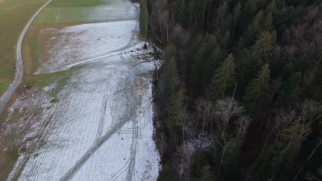 Aerial view of the small, scenic Klausbach meanders through the Alpine landscape, on a sunny day