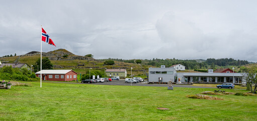 Farsund, Norway - July 02 2023: snow-covered gas station with price board in winter landscape.