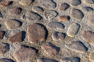 a part of the road made of cobblestones, an old-style pavement