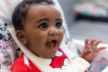 Spontaneous reaction of a child when introduced to food, eating for the first time. Rio de Janeiro,...