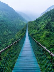 Obraz premium Scenic View of Lush Green Landscape from a Suspension Bridge in Mountain Valley