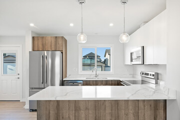 A kitchen with a white counter and wooden cabinets
