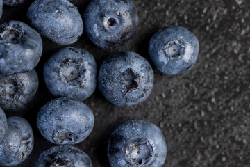 a pile of blueberries scattered on the board