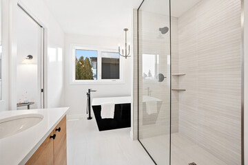 A bathroom with a white tub and a sink
