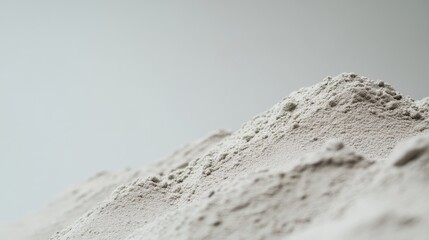 Fototapeta premium Close-up view highlights a neat arrangement of cement, revealing its granularity and texture, set against a minimalistic white background with gentle shadows