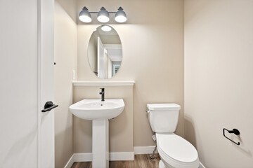 A bathroom with a white toilet and sink
