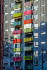 Fototapeta premium colorful balconies on modern residential building with glass panels.