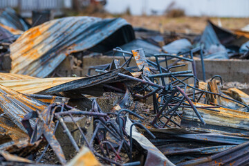 pile of twisted rusted metal debris from collapsed structure.