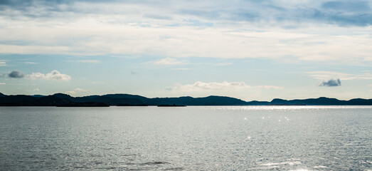 serene seascape with sparkling waters and distant islands.