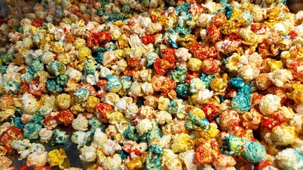 A pile of colorful popcorn with red, yellow, and blue pieces