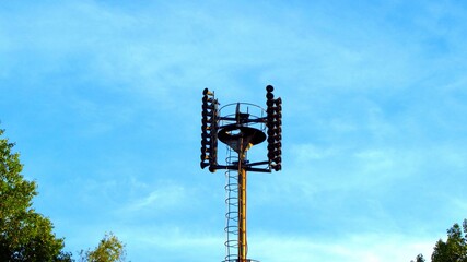 A tall pole with many lights on top of it