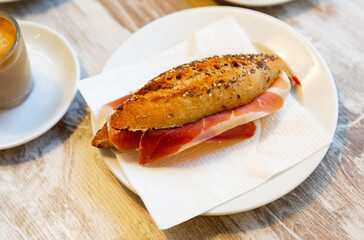 Appetizing delicious ham sandwich and a cup of hot coffee. Healthy breakfast