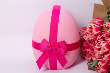 A vibrant pink Easter egg with a smooth, glossy surface, set against a neutral or festive background. Perfect for holiday decorations, Easter celebrations, and seasonal designs.