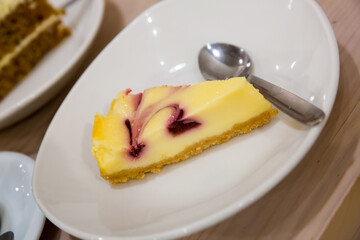 Slice of easy and tasty berry swirl cheesecake. Delicious homemade baking..