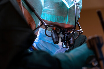 Surgeons wear magnifying glasses in the operating room. Intraoperative magnification using surgical...